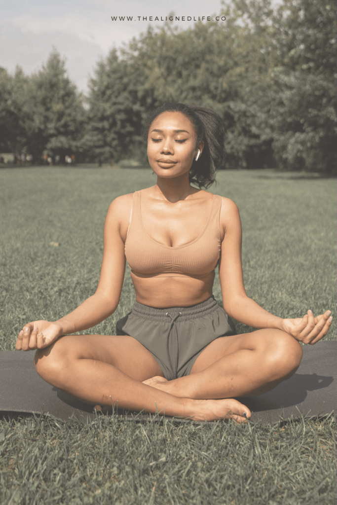 woman meditating outdoors with text 7 Of The Most Powerful Money Affirmations Ever