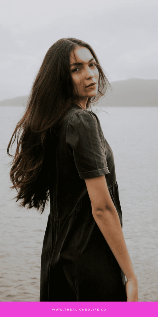 woman with long brown hair standing in front of the ocean | 3 Methods for Instant Manifestation | The Aligned Life Manifestation Blog