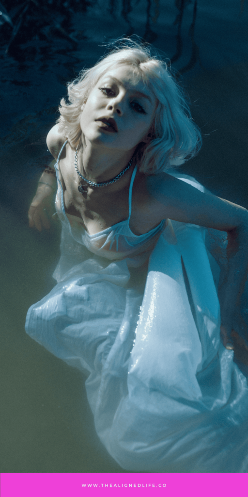 blonde woman in white dress in water | Shadow Work For Your Astrological Sign | The Aligned Life Manifestation Blog