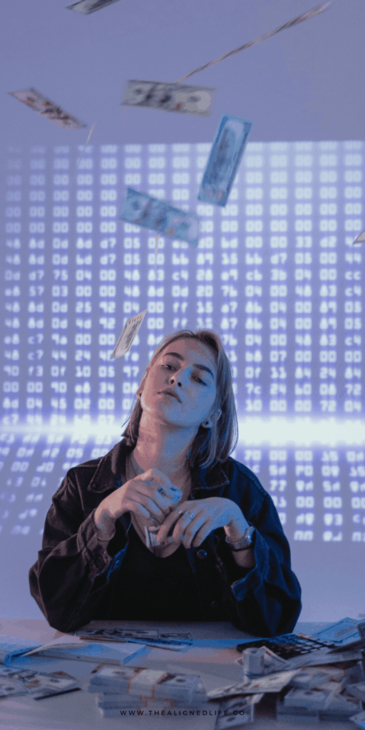woman sitting a desk throwing money in the air | How To Manifest Money | The Aligned Life Manifestation Blog