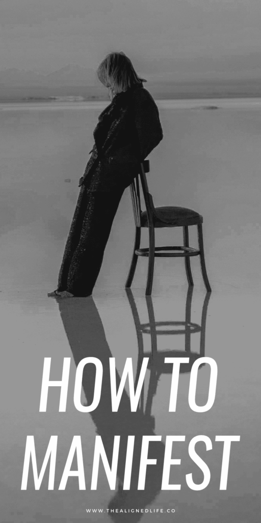 woman leaning on a chair in low water purple mountains reflection | How To Manifest | The Aligned Life Manifestation Blog