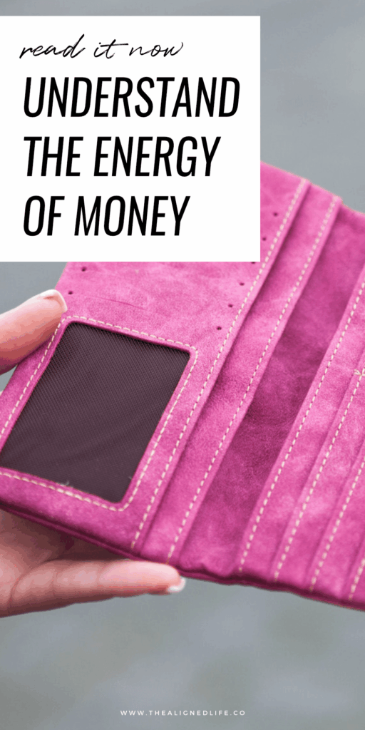 woman holding an empty pink wallet | Understand The Energy Of Money | The Aligned Life Manifestation Blog