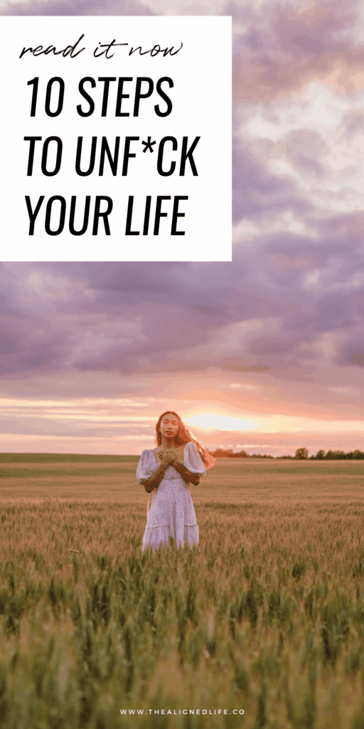 woman in a field at sunset | How To Unfuck Your Life | The Aligned Life Manifestation + Spirituality Blog