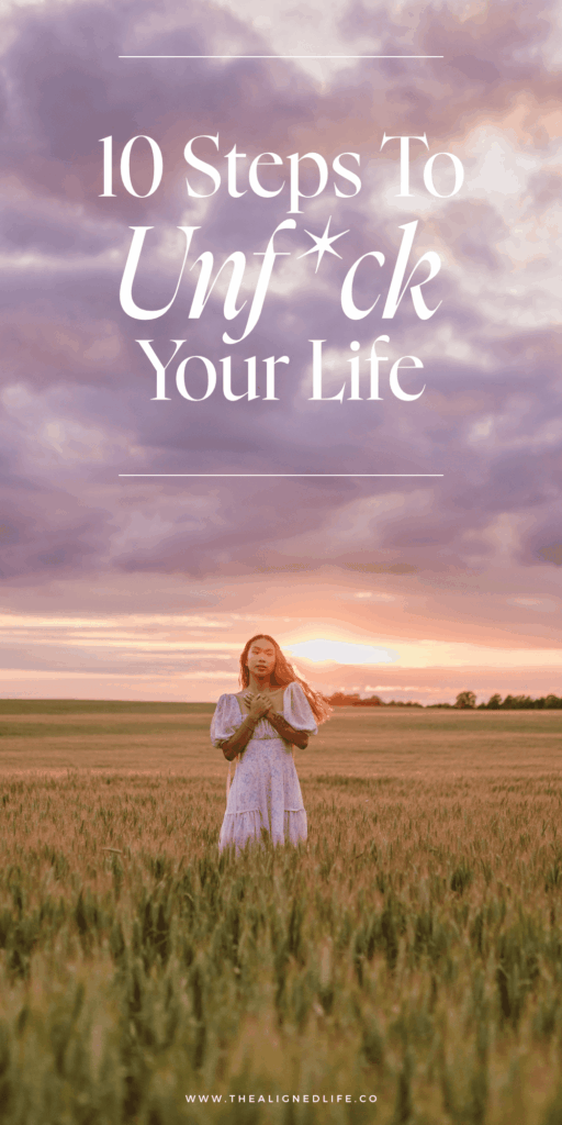 woman in a field at sunset | How To Unfuck Your Life | The Aligned Life Manifestation + Spirituality Blog