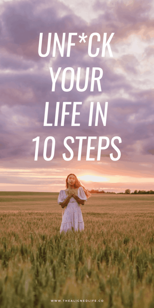 woman in a field at sunset | How To Unfuck Your Life | The Aligned Life Manifestation + Spirituality Blog