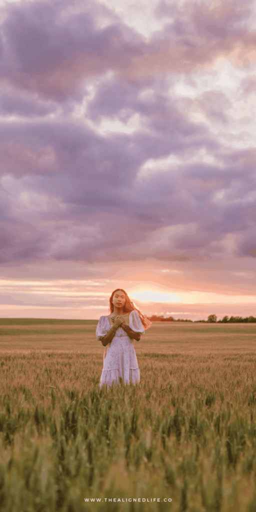woman in a field at sunset | How To Unfuck Your Life | The Aligned Life Manifestation + Spirituality Blog