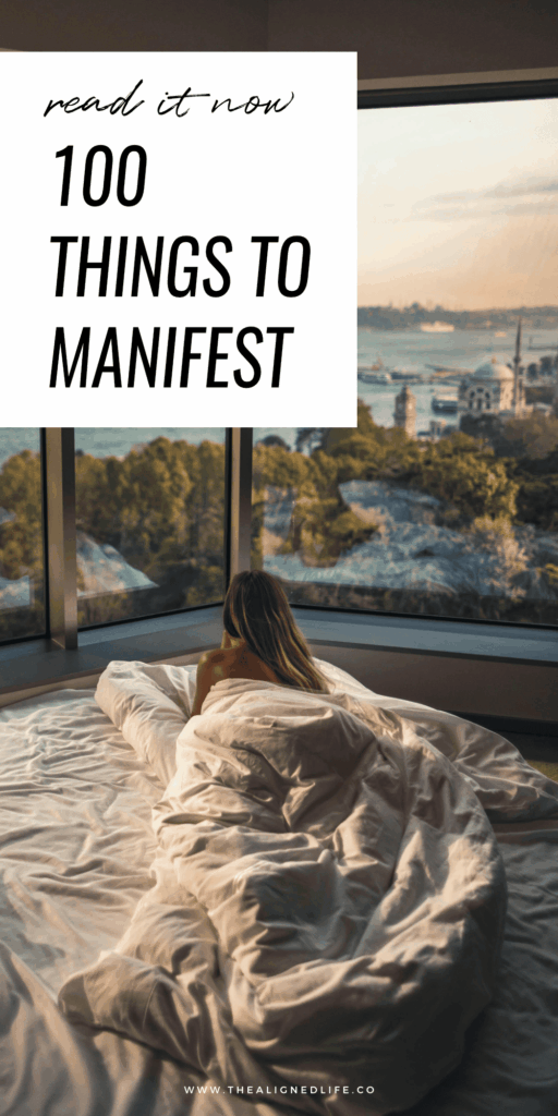 woman in a bed looking out at the beach | 100 Things To Manifest | The Aligned Life Manifestation Blog