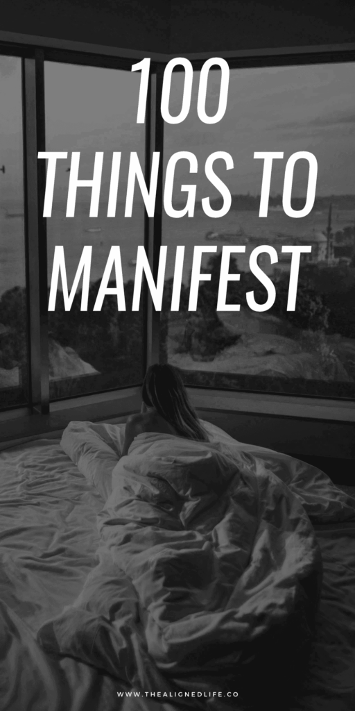 woman in a bed looking out at the beach | 100 Things To Manifest | The Aligned Life Manifestation Blog