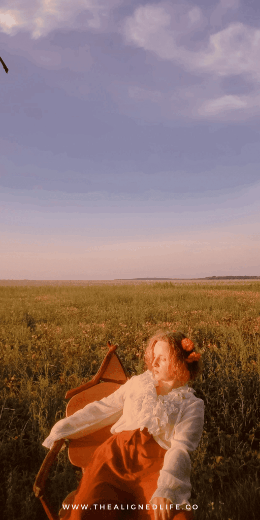 woman with a flower crown sitting in a chair in a field | How To Develop Your Intuition | The Aligned Life Manifestation Blog