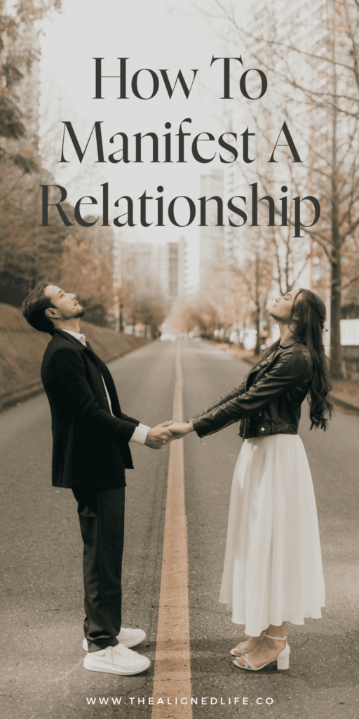 man and woman holding hands in a road with tall city buildings and trees behind them | How To Manifest A Relationship | The Aligned Life Manifestation Blog