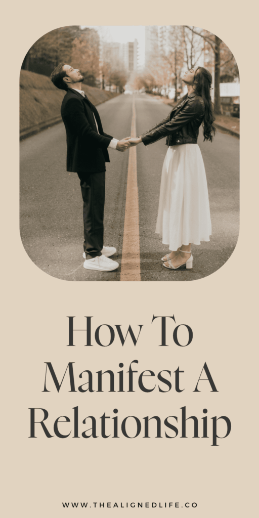 man and woman holding hands in a road with tall city buildings and trees behind them | How To Manifest A Relationship | The Aligned Life Manifestation Blog