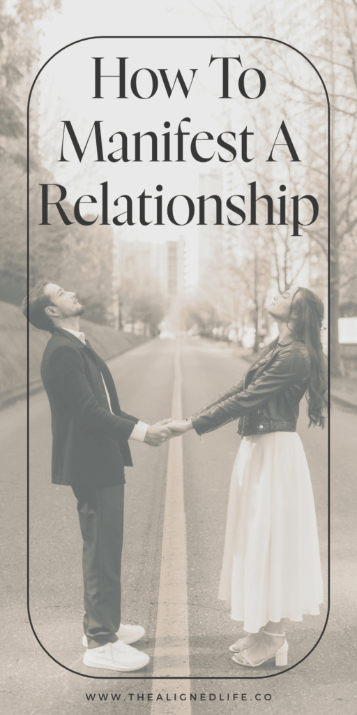 man and woman holding hands in a road with tall city buildings and trees behind them | How To Manifest A Relationship | The Aligned Life Manifestation Blog