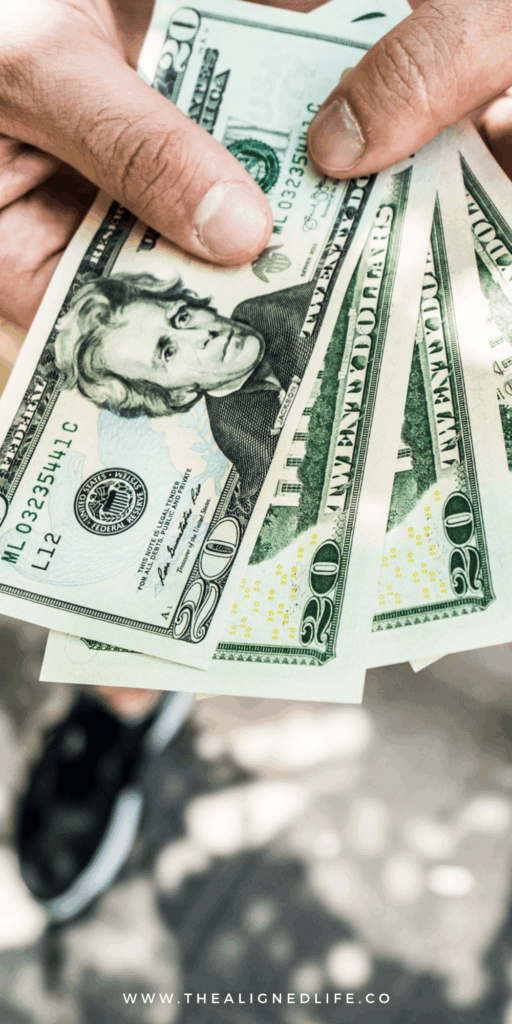 hands holding some $20 bills | 6 Keys To Manifest Money FAST! | The Aligned Life Manifestation Blog