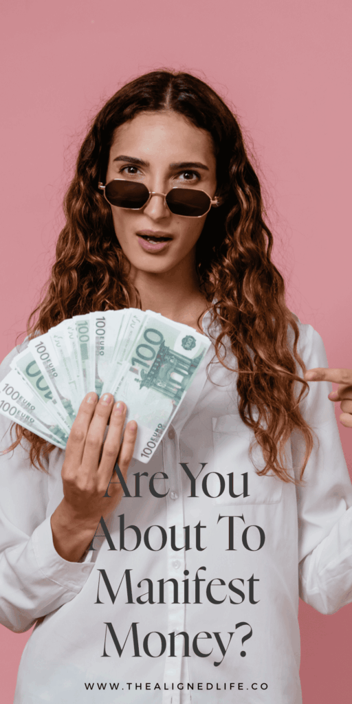 woman holding a handful of cash in front of a pink wall | Signs That Money Is Coming Your Way | The Aligned Life Manifestation Blog