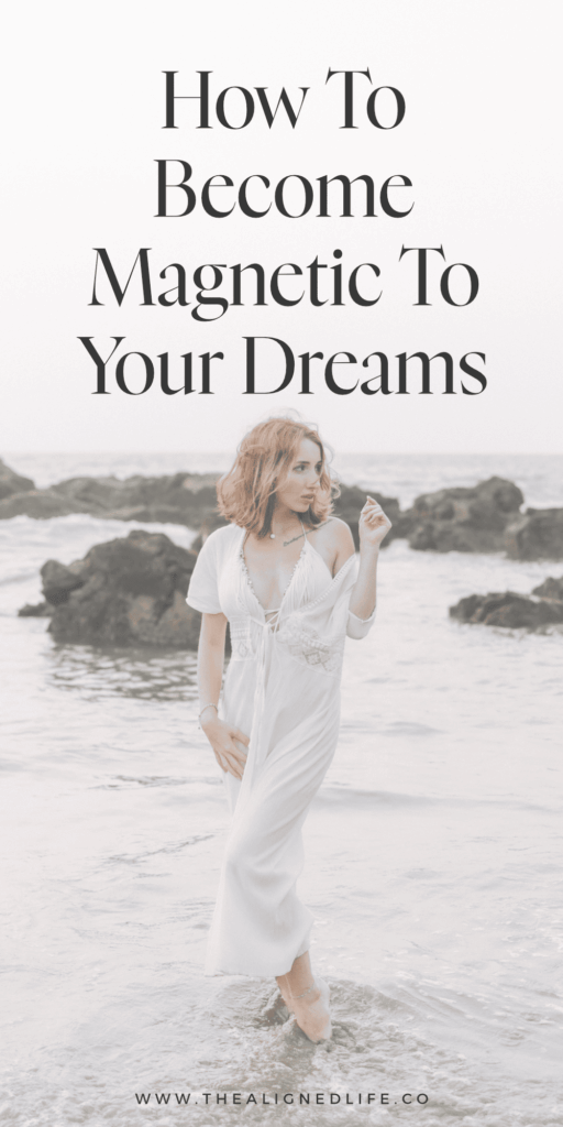 redheaded woman in a white dress standing in water at the beach | How To Become Magnetic To Your Dreams | The Aligned Life Manifestation Blog