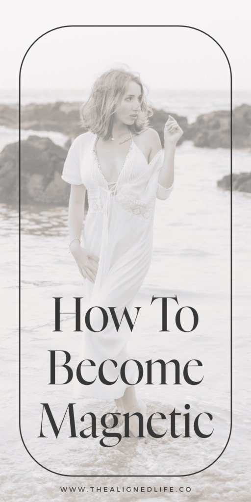 redheaded woman in a white dress standing in water at the beach | How To Become Magnetic To Your Dreams | The Aligned Life Manifestation Blog