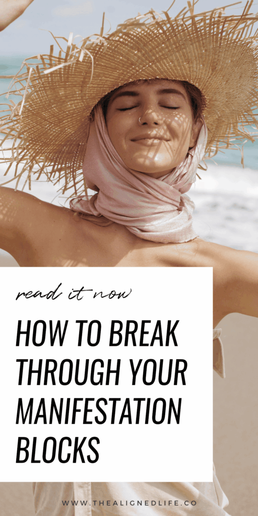 woman smiling in a straw hat on the beach | How to Break Through Your Manifestation Blocks | The Aligned Life Manifestation Blog
