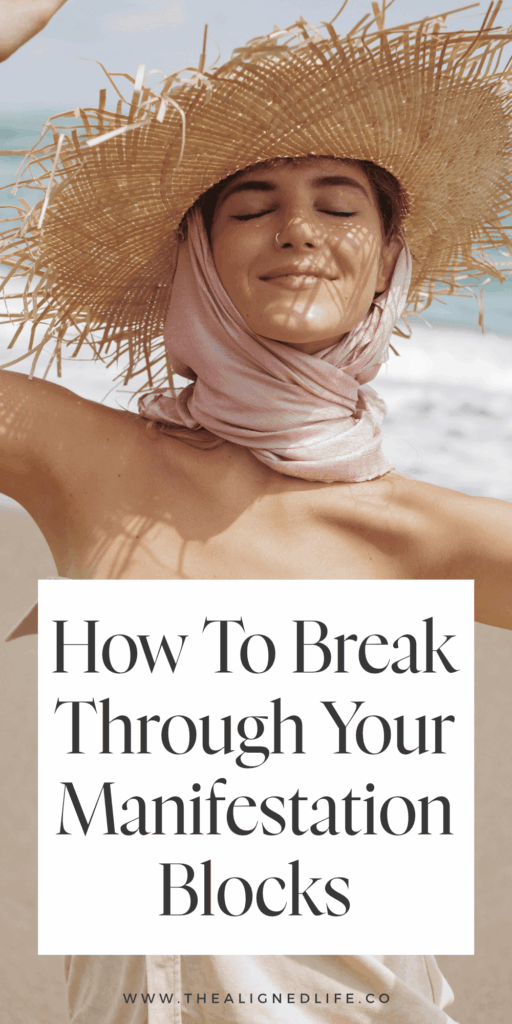 woman smiling in a straw hat on the beach | How to Break Through Your Manifestation Blocks | The Aligned Life Manifestation Blog
