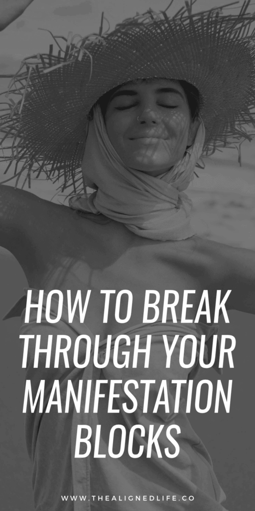 woman smiling in a straw hat on the beach | How to Break Through Your Manifestation Blocks | The Aligned Life Manifestation Blog