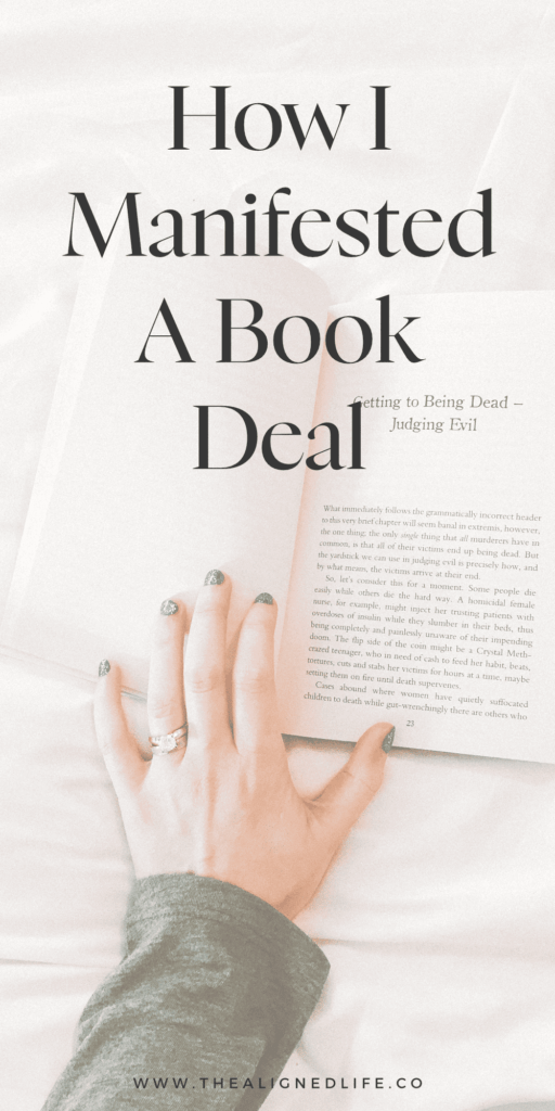 hand on a white bed with a book | How I Manifested A Book Deal | The Aligned Life Manifestation Blog