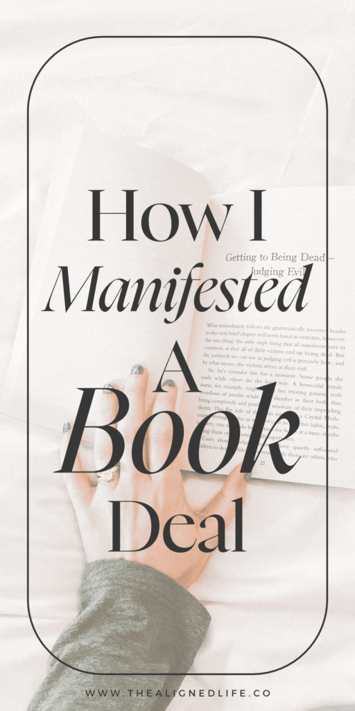 hand on a white bed with a book | How I Manifested A Book Deal | The Aligned Life Manifestation Blog