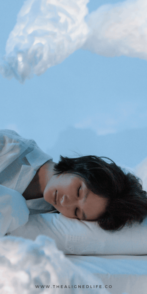 woman in the clouds with her head on a pillow | How To Use The Pillow Manifestation Method | The Aligned Life Manifestation Blog
