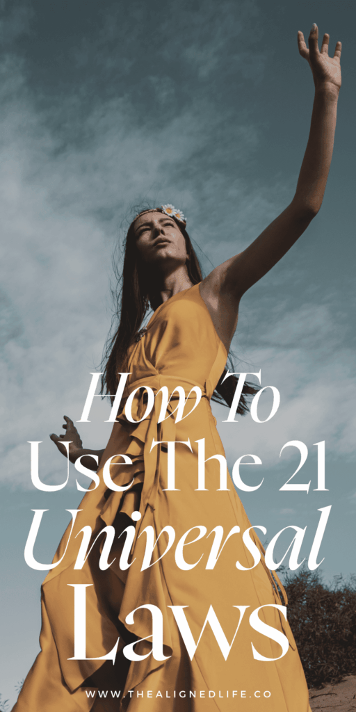 woman in a yellow dress with her hand against the sky | How To Use The 21 Universal Laws | The Aligned Life Manifestation Blog