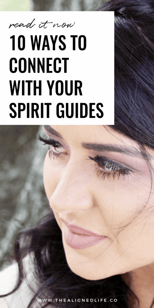brunette woman looking over her shoulder | 10 Ways To Connect With Your Spirit Guides | The Aligned Life Manifestation Blog