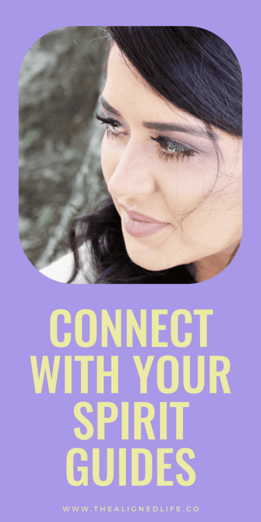 brunette woman looking over her shoulder | 10 Ways To Connect With Your Spirit Guides | The Aligned Life Manifestation Blog