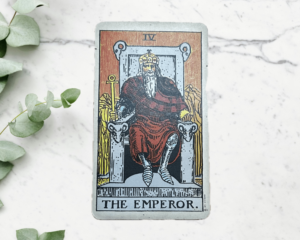 white marble table with eucalyptus & The Emperor Tarot Card 4