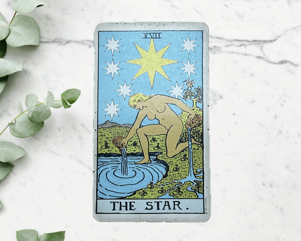 white marble table with eucalyptus & The Star Tarot Card 17